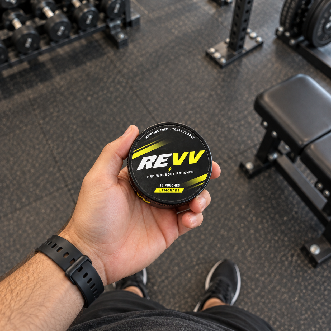 REVV Lemonade can held in hand at the gym